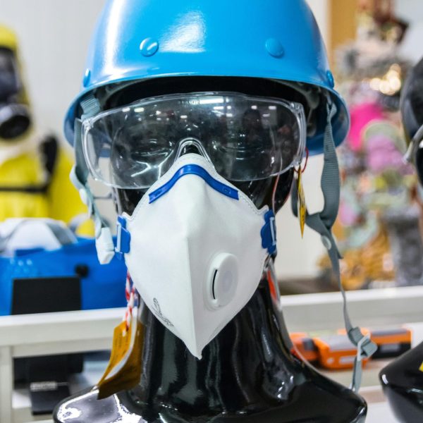 Mannequin showcasing blue helmet, goggles, and mask for safety and protection.